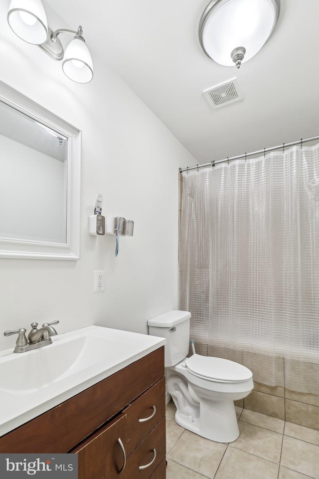 full bath with toilet, vanity, tile patterned flooring, and visible vents