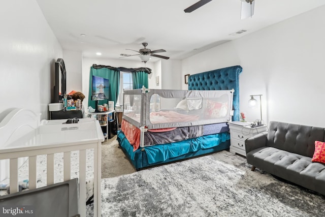 carpeted bedroom with visible vents and ceiling fan