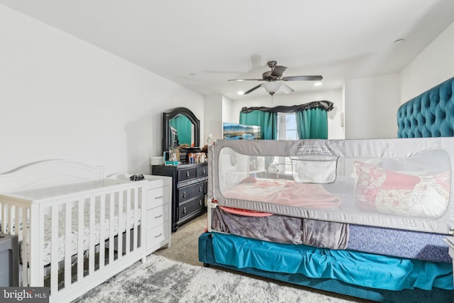 carpeted bedroom with ceiling fan