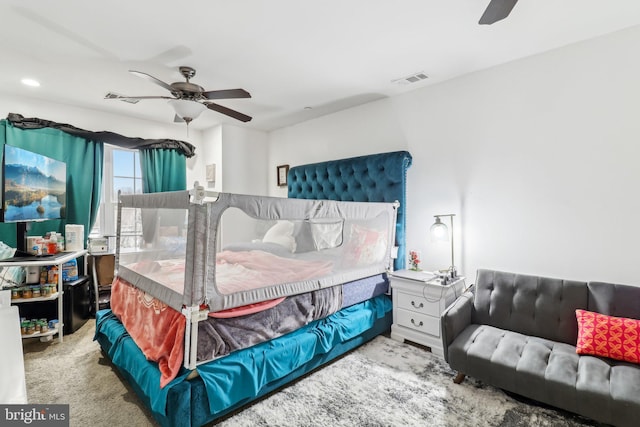 bedroom with carpet floors, visible vents, and ceiling fan