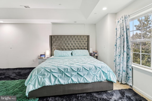 carpeted bedroom featuring recessed lighting, visible vents, and baseboards