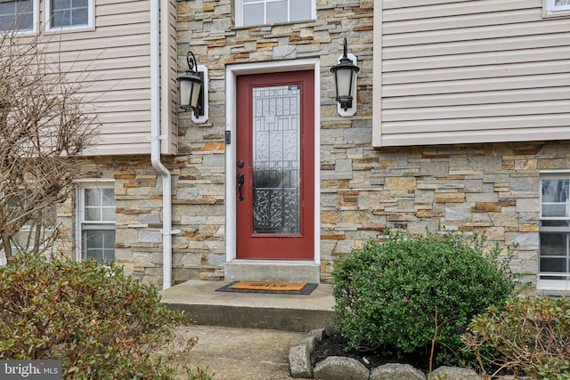 doorway to property with stone siding