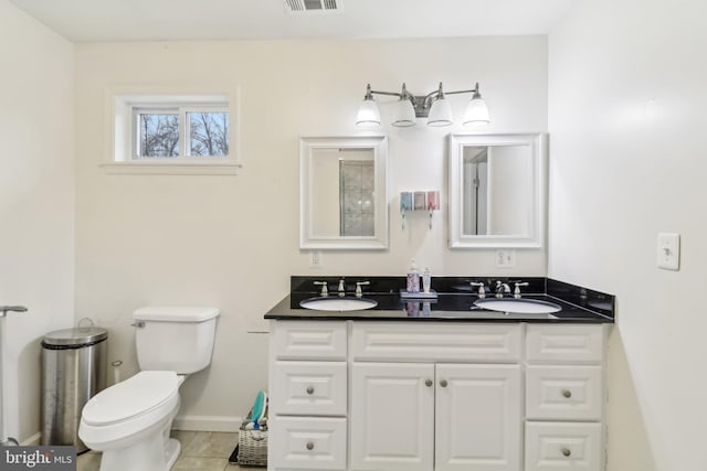 bathroom with visible vents, a sink, toilet, and tile patterned floors