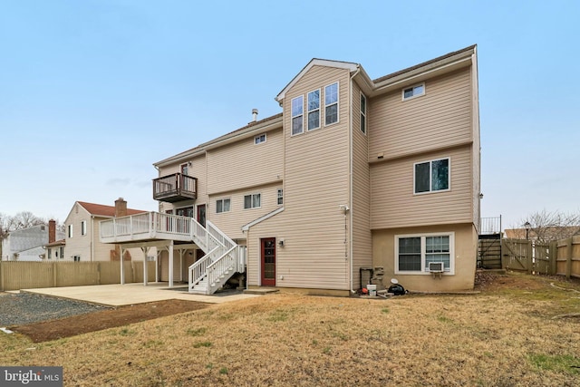 back of property with a lawn, a fenced backyard, stairway, cooling unit, and a patio area