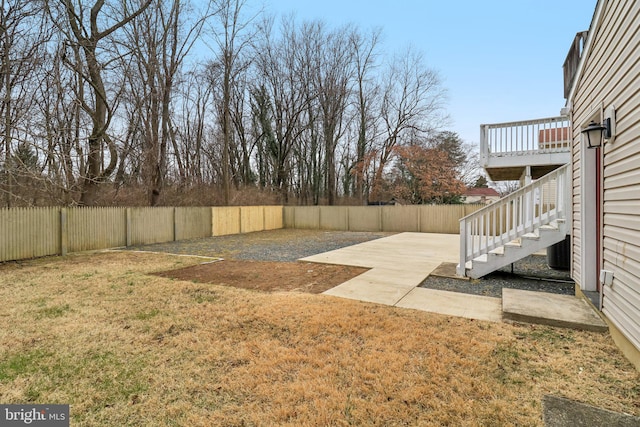 view of yard featuring stairway and a fenced backyard