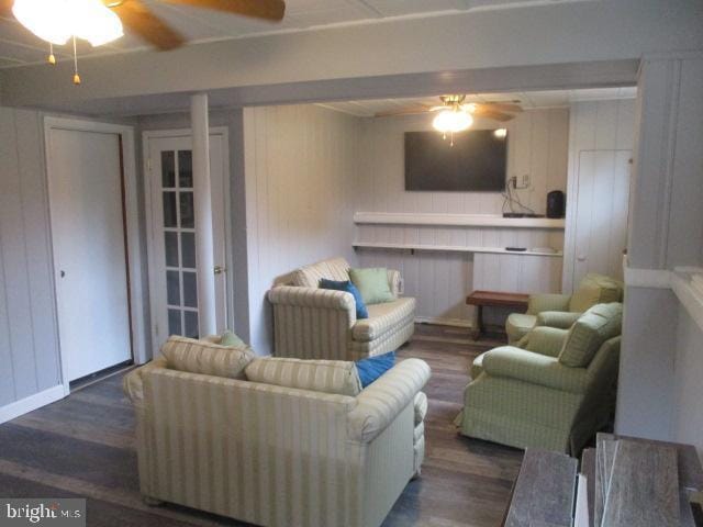 living area with ceiling fan and wood finished floors