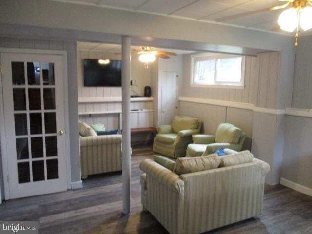 sitting room with ceiling fan and wood finished floors