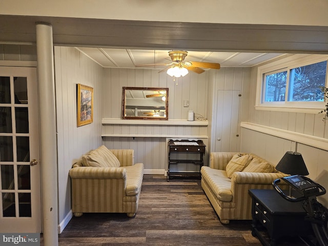 sitting room featuring dark wood-type flooring and a ceiling fan