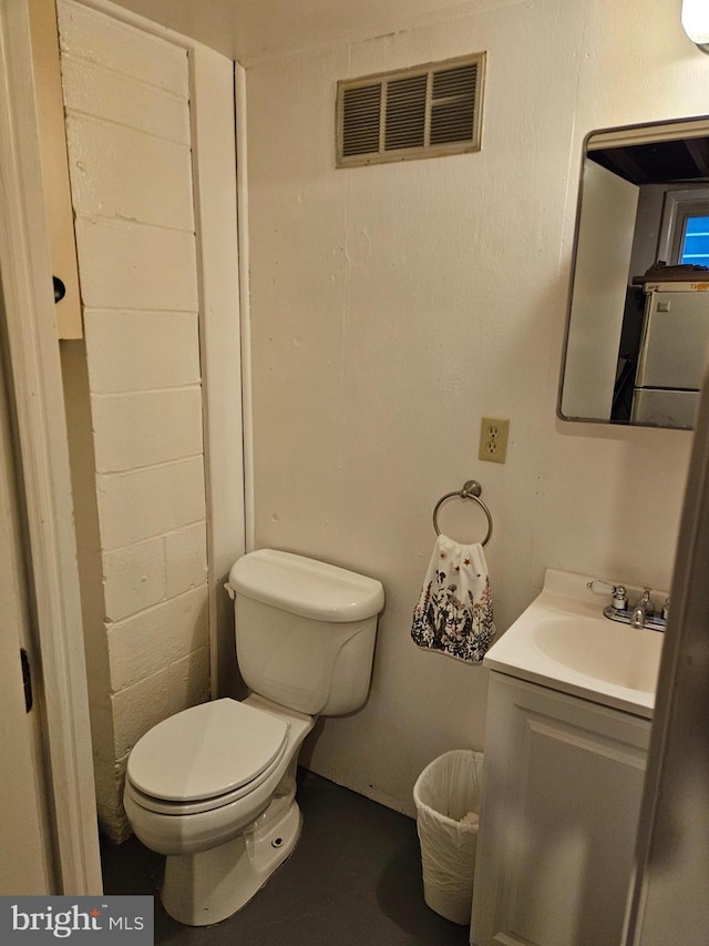 bathroom with toilet, visible vents, and vanity