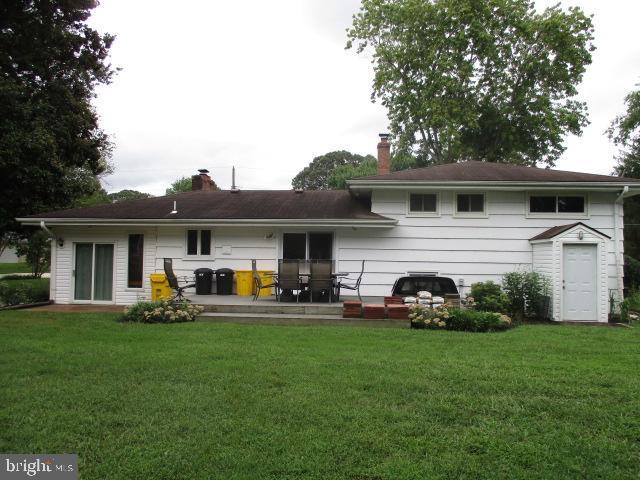 back of house with a lawn