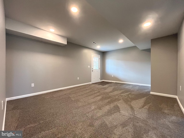 empty room with visible vents, recessed lighting, baseboards, and dark colored carpet