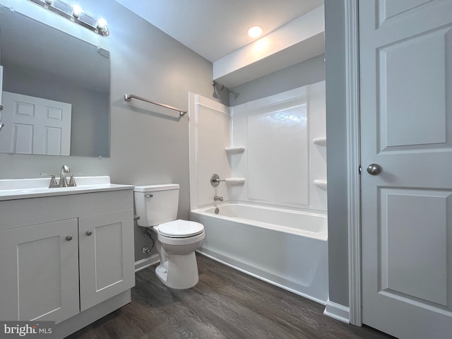 bathroom with vanity, wood finished floors, baseboards, toilet, and shower / bathtub combination