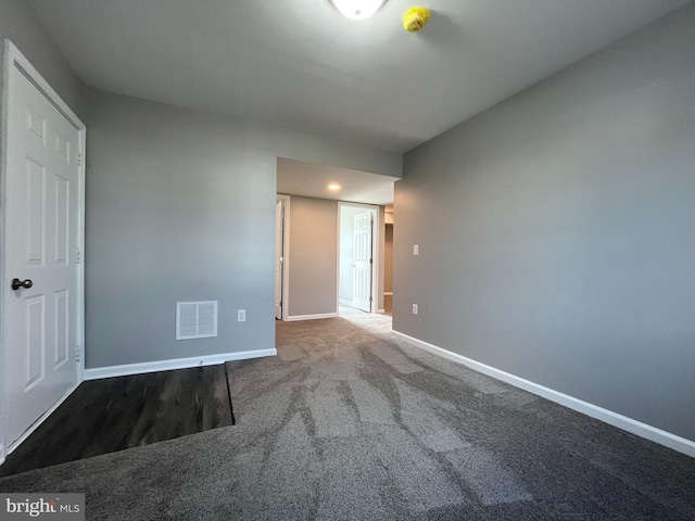 unfurnished bedroom featuring visible vents, baseboards, and carpet floors