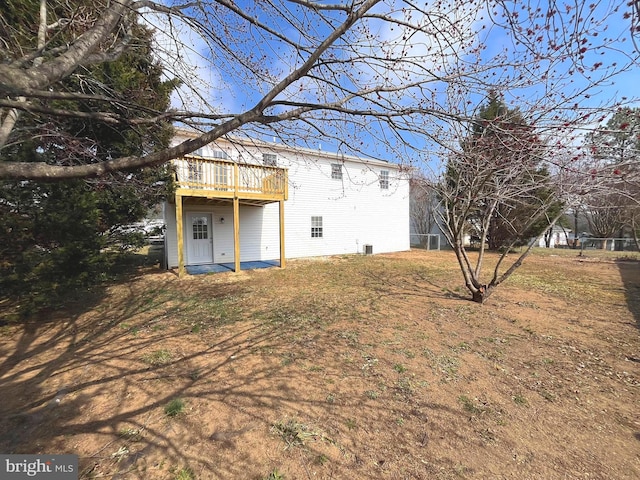 rear view of property featuring a wooden deck