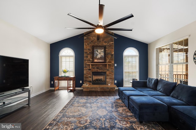 living area with wood finished floors, a fireplace, baseboards, and vaulted ceiling