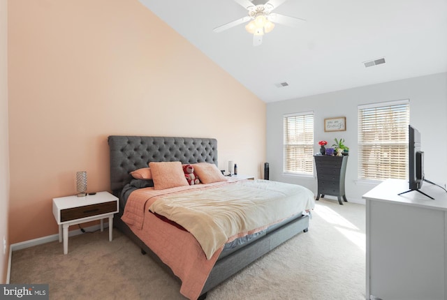 bedroom featuring visible vents, lofted ceiling, light colored carpet, and baseboards