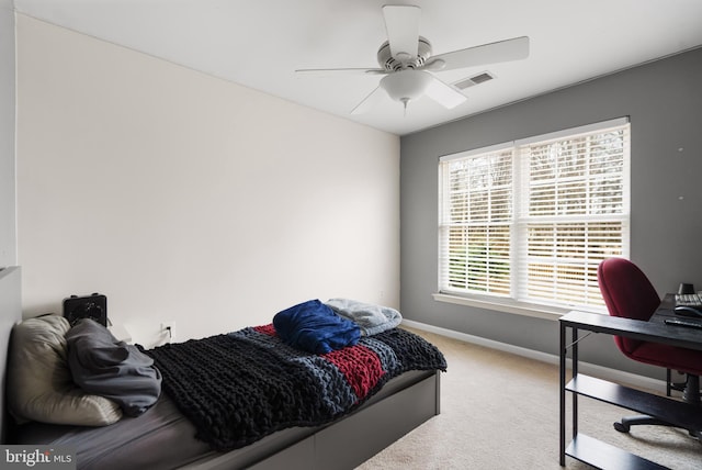 carpeted bedroom featuring visible vents, baseboards, and a ceiling fan