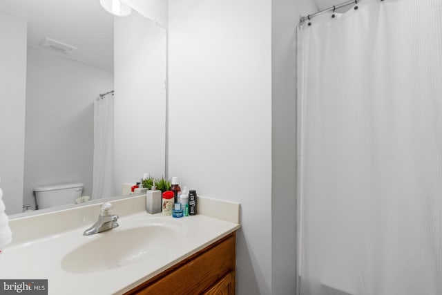 bathroom with toilet and vanity