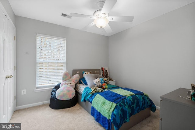 bedroom featuring carpet, visible vents, baseboards, ceiling fan, and a closet