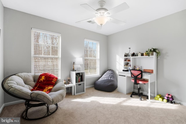 living area with carpet, baseboards, and ceiling fan