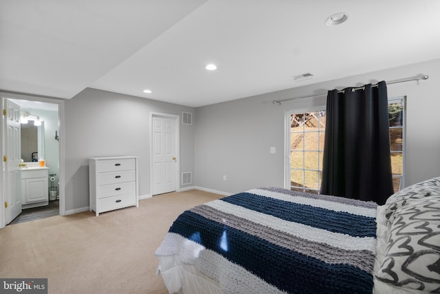 bedroom with recessed lighting, visible vents, light carpet, and baseboards