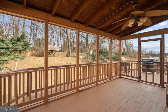 sunroom featuring a ceiling fan, wooden ceiling, and vaulted ceiling with beams