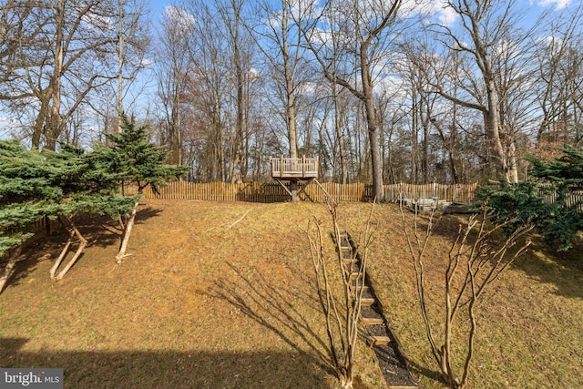 view of yard with a wooden deck and fence