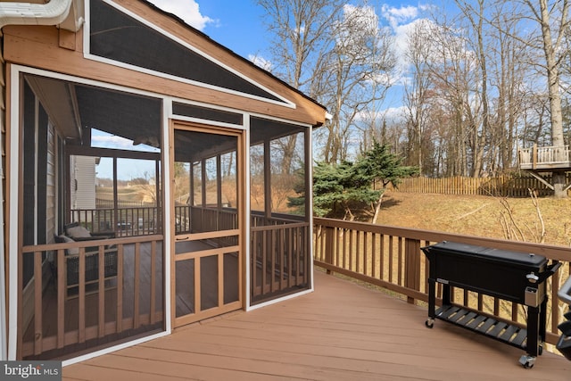 wooden deck with a sunroom