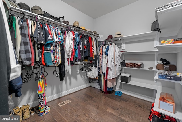 spacious closet featuring visible vents and wood finished floors