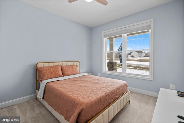 bedroom with baseboards, ceiling fan, and light colored carpet