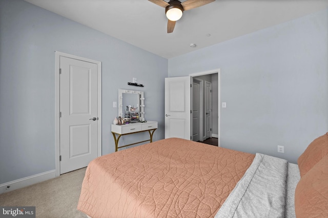 carpeted bedroom with a ceiling fan and baseboards