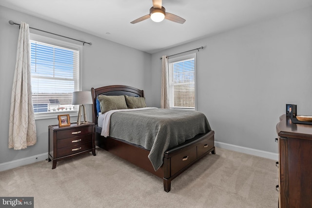 bedroom with light carpet, baseboards, and a ceiling fan