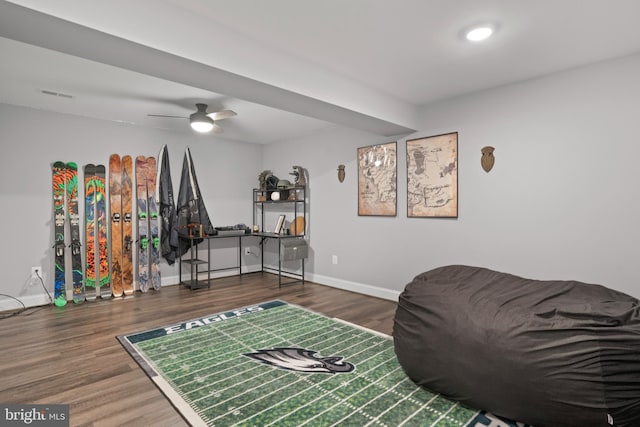 interior space featuring visible vents, ceiling fan, baseboards, and wood finished floors