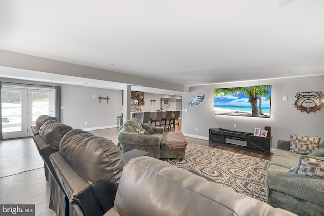 living area featuring baseboards and wood finished floors