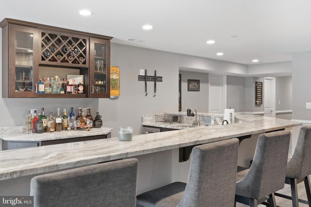 bar with wet bar, visible vents, a sink, and recessed lighting