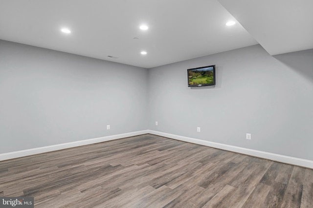 finished below grade area with recessed lighting, visible vents, baseboards, and wood finished floors