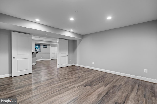 finished basement with baseboards, wood finished floors, and recessed lighting