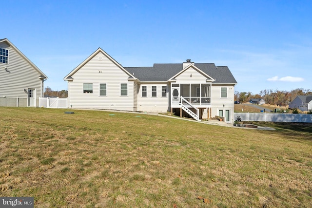 back of property with a lawn, a sunroom, a fenced backyard, a chimney, and a patio area