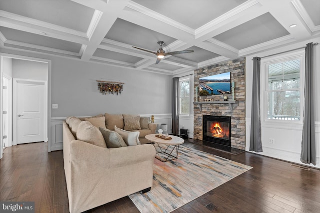 living room with visible vents, coffered ceiling, dark wood finished floors, beamed ceiling, and a fireplace