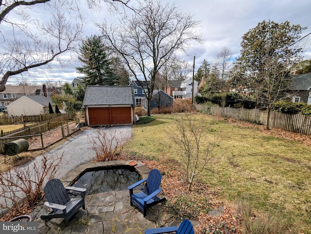 view of yard featuring a patio, an outdoor fire pit, an outdoor structure, and fence