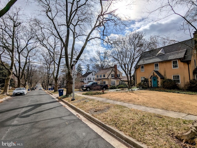 view of street featuring sidewalks, a residential view, and curbs