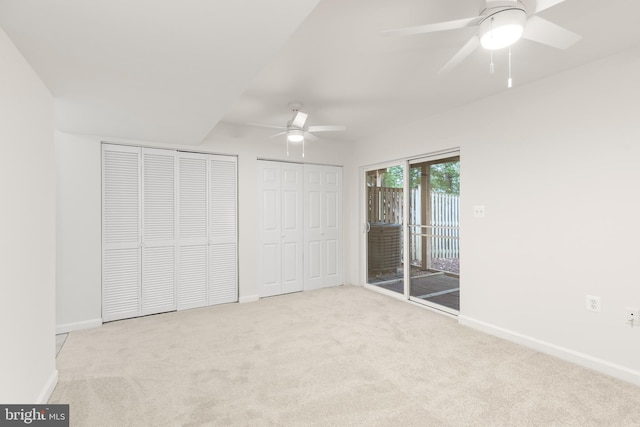 6185 Newton Ln, Bealeton, VA 22712 - unfurnished bedroom with access to outside, carpet floors, two closets, baseboards, and ceiling fan