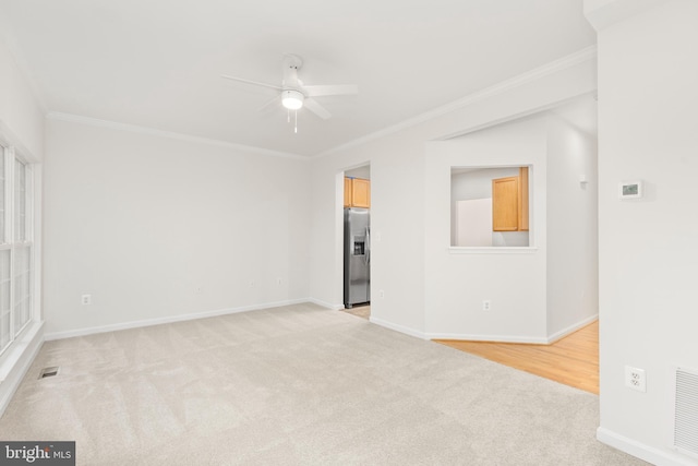 6185 Newton Ln, Bealeton, VA 22712 - spare room with a ceiling fan, light colored carpet, crown molding, and baseboards