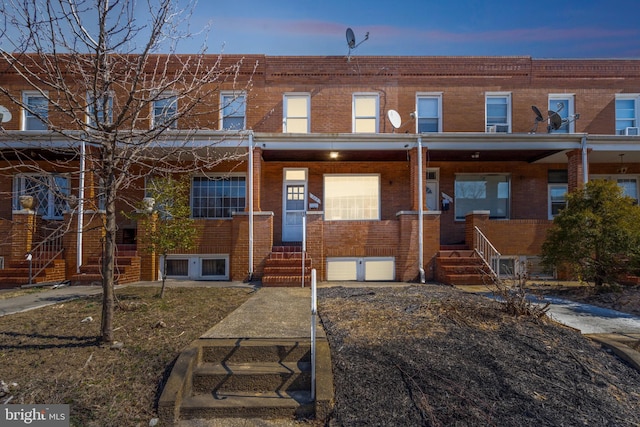 townhome / multi-family property featuring entry steps and brick siding