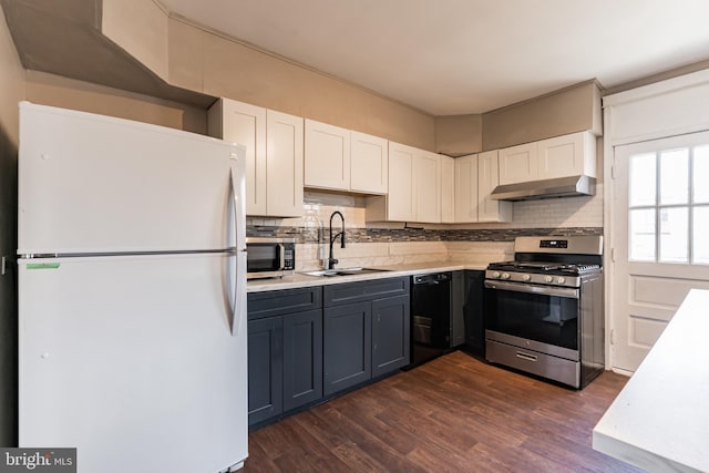 305 Drew St, Baltimore, MD 21224 - kitchen with appliances with stainless steel finishes, light countertops, a sink, and under cabinet range hood