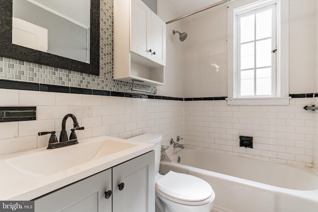 305 Drew St, Baltimore, MD 21224 - bathroom with a washtub, vanity, toilet, and tile walls
