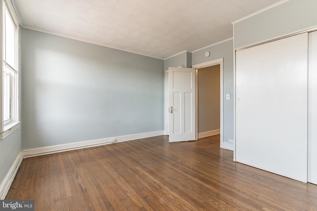 305 Drew St, Baltimore, MD 21224 - unfurnished bedroom with ornamental molding, a closet, baseboards, and wood finished floors
