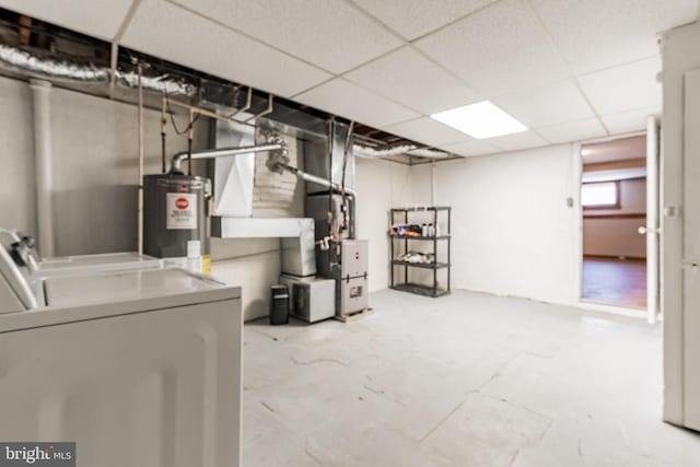 305 Drew St, Baltimore, MD 21224 - below grade area with heating unit, water heater, a drop ceiling, and washing machine and clothes dryer