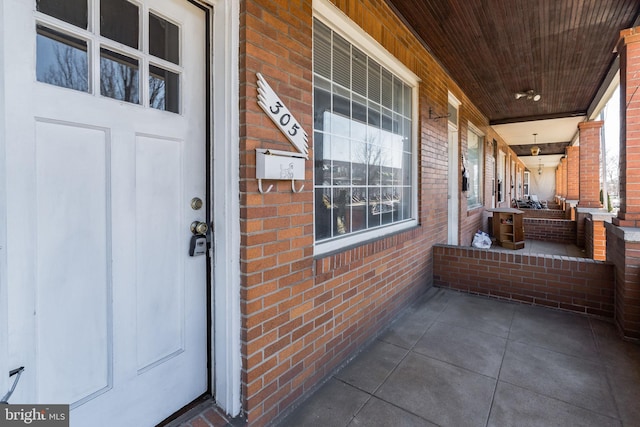 305 Drew St, Baltimore, MD 21224 - exterior space with covered porch and brick siding