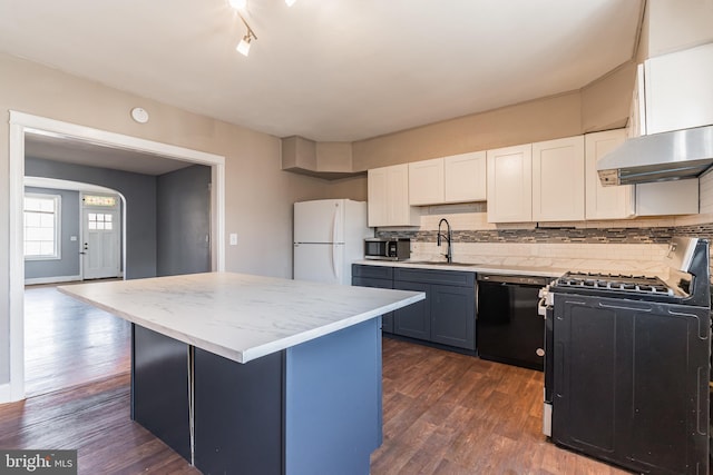 305 Drew St, Baltimore, MD 21224 - kitchen featuring dark wood-type flooring, a sink, backsplash, a center island, and black appliances